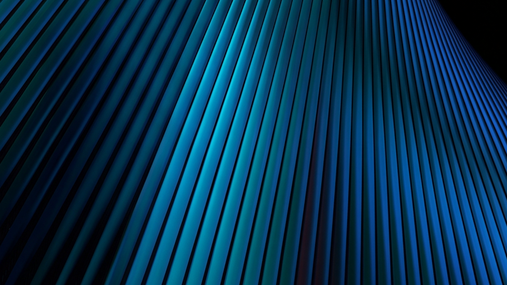 Abstract blue and teal lines sweep diagonally across a dark background in a layered wave pattern.