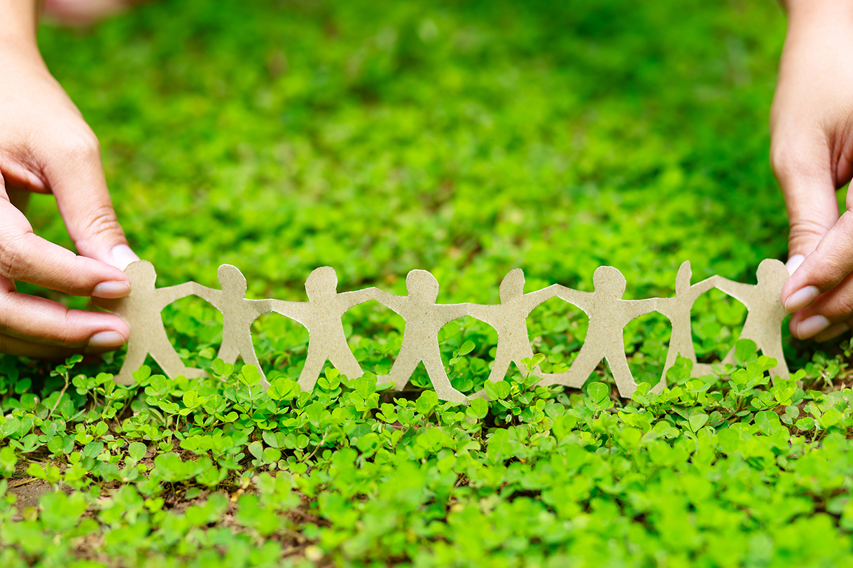 Human chain paper on green creeper plant, CSR (coporate social responsibility) or teamwork concept