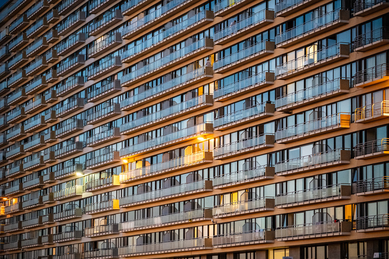 All Glass residential building at sunset - Population growth and demand for housing 
